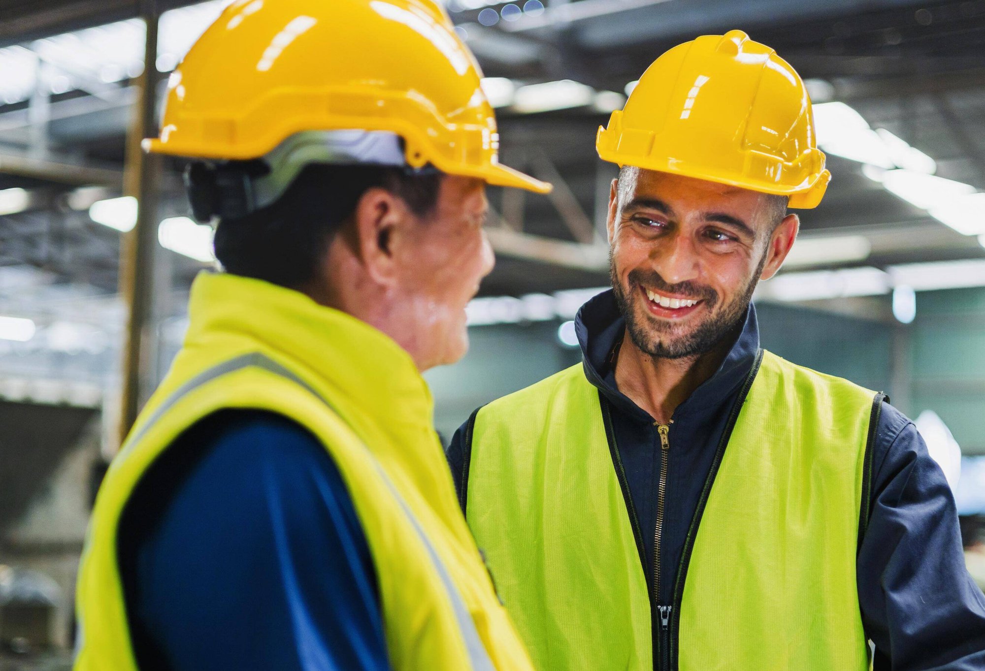 two warehouse employees in hard hats