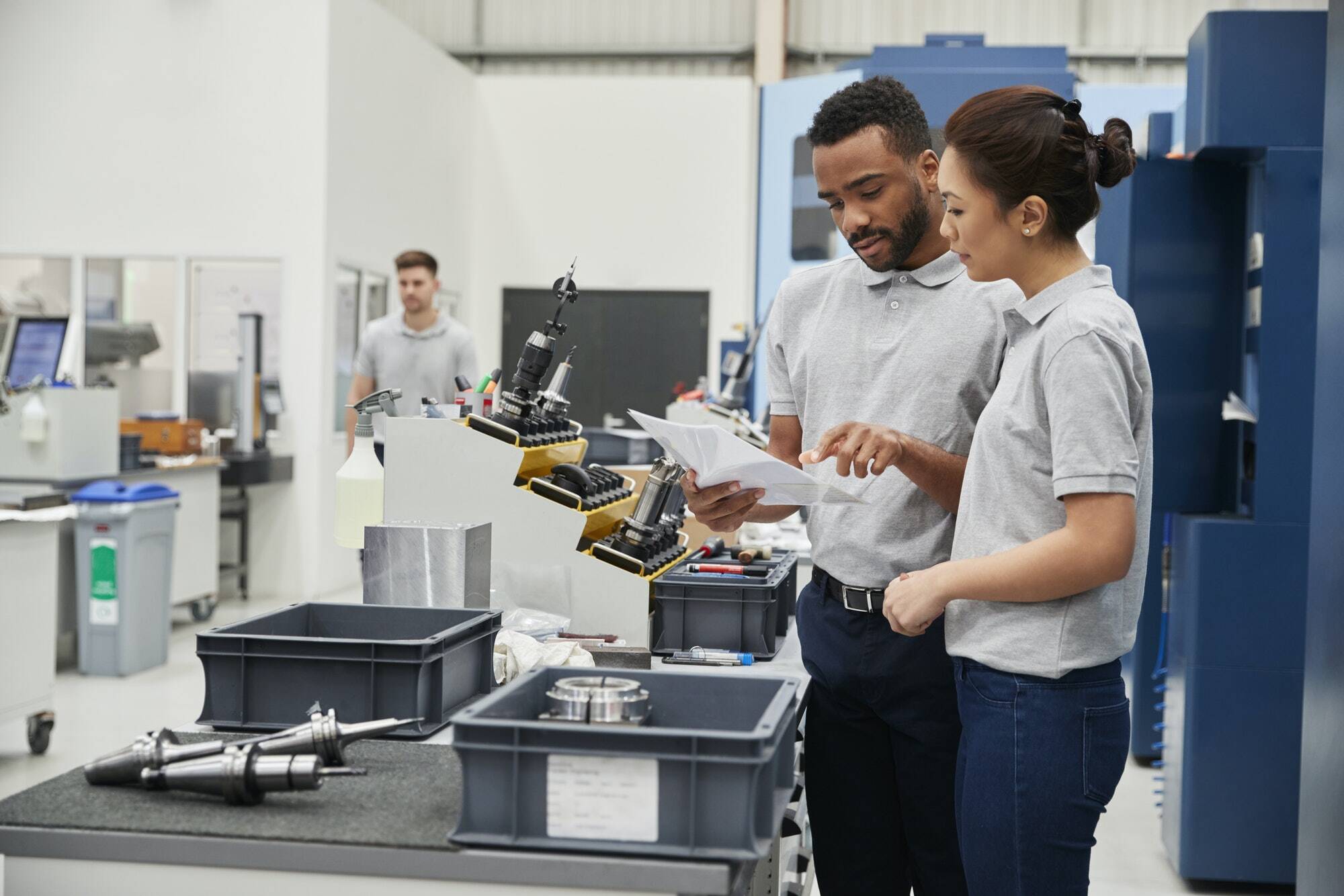 engineer-and-apprentice-meet-on-floor-of-engineering-workshop